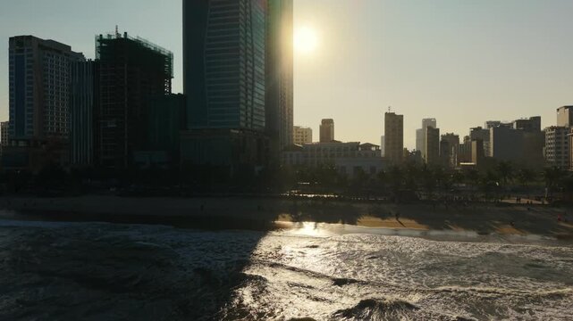 Vietnam, Da Nang Sunlit Da Nang Skyline Over Ocean, Dramatic Highrise Silhouette And Shimmering Surf Reflecting Low Sun, Coastal Business District And Beachfront Hotels, Morning Light