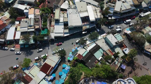 Vietnam, Da Nang Aerial View Da Nang Rooftop Market Blue Umbrellas And Narrow Street Lanes, Vendors Selling Goods, Motorcycles Weaving Through Traffic, Colorful Canopies Casting Shadows,