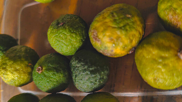 Group of fresh kaffir limes or limau in a container