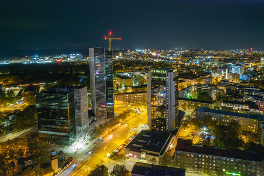 Aerial night view of modern city skyline with skyscrapers