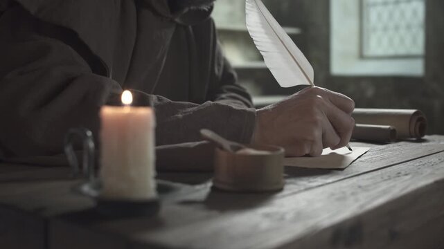 Monastic scribe in a brown robe writing with a long white quill on parchment next to a burning candle and scrolls on a wooden table inside a medieval scriptorium