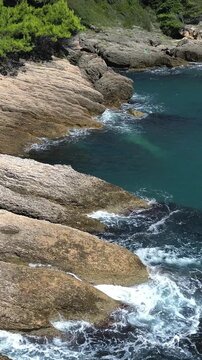 Aerial view of the stunning rocky coastline with crashing waves near Ulcinj, Montenegro