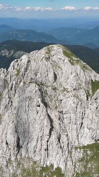 Majestic aerial view of the rocky cliff face of maglić mountain, the highest peak in bosnia and herzegovina, on a bright sunny day