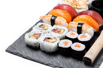Assorted sushi platter with nigiri and maki rolls isolated on white background © chandlervid85