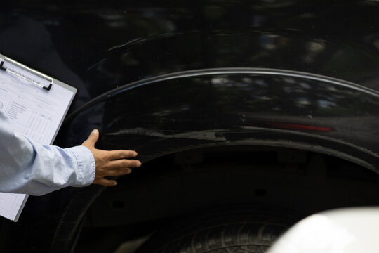 Car Insurance Inspector Examining Vehicle Damage After Accident