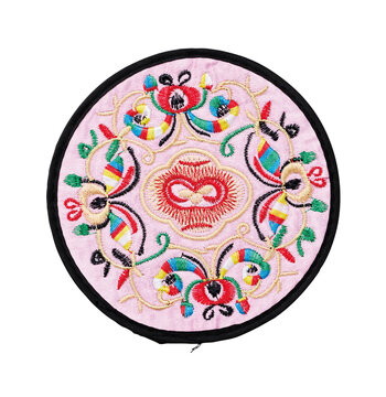 Pastel pink silk embroidered round coaster with traditional floral pattern isolated on white background