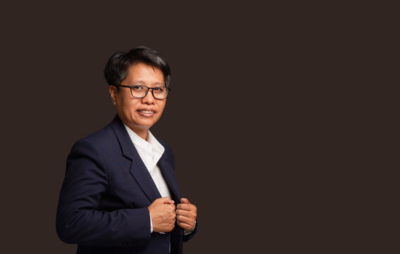 Short haired businesswoman adjusting suit jacket