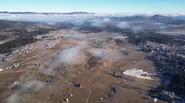 Drone View of Zabljak City in Montenegro During Winter with Foggy Valley