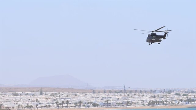 Military Helicopter Taking Off on Maritime Patrol Mission Above Atlantic Ocean Corridor in Canary Islands Spain