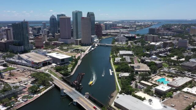 Drone perspective of Tampa, Florida's skyline meeting Hillsborough Bay, where towering buildings, bridges, and Gulf waters combine to define the city's coastal energy.