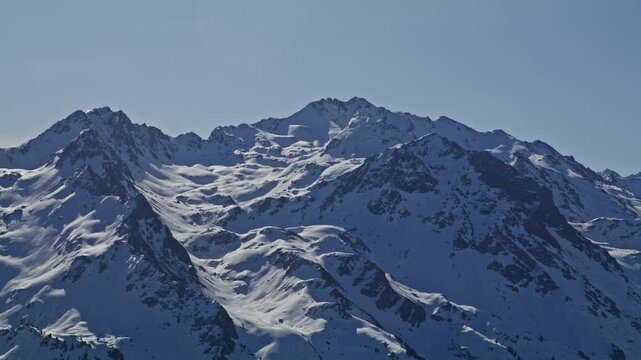 Panoramic view of Rosablanche and Mont Gel&eacute; covered in fresh snow, filmed from Nendaz in the Swiss Alps. A pristine alpine mountain landscape showcasing the dramatic peaks of the 4 Vall&eacute;es ski region.