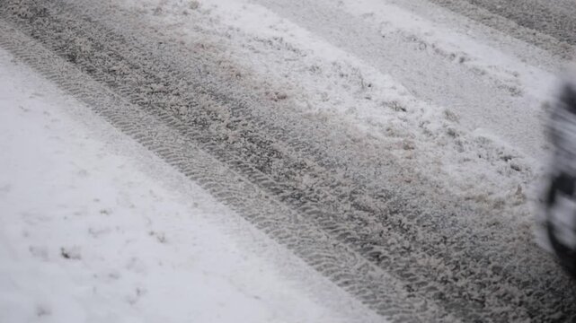 Slow Motion Cars Driving on Snowy Winter Road Leaving Tire Tracks, Cold Weather Transportation Scene