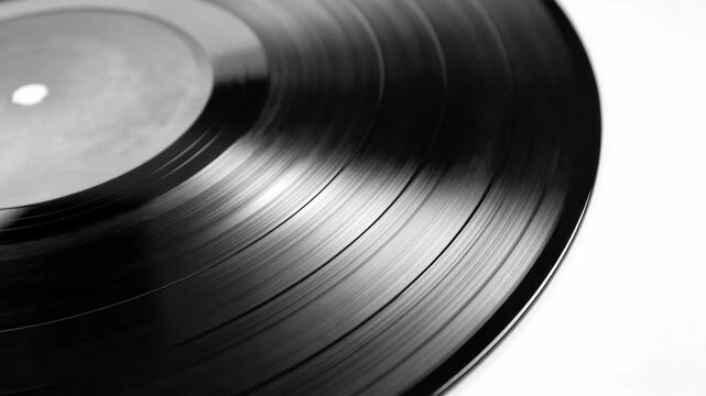 A collection of classic vinyl records in a stack with one record facing up to showcase its label and grooves
