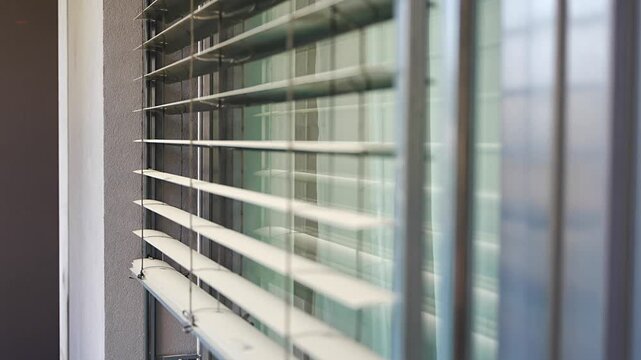 Exterior window blinds automatically opening to let natural daylight into a modern apartment. Smart home automation and energy efficient living concept.