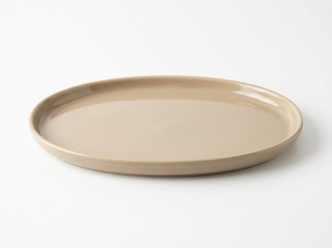 Empty round beige ceramic plate on a clean surface