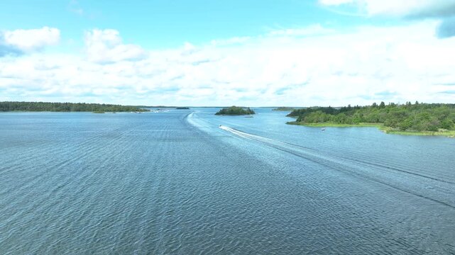Motorboat cruising on a lake through a scenic archipelago