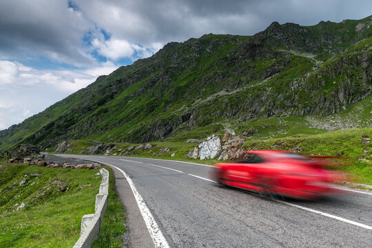 Red Car Driving on the Transfagarasan Highway in Romania