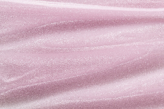 Pink cosmetic liquid gel shimmer texture with brush strokes