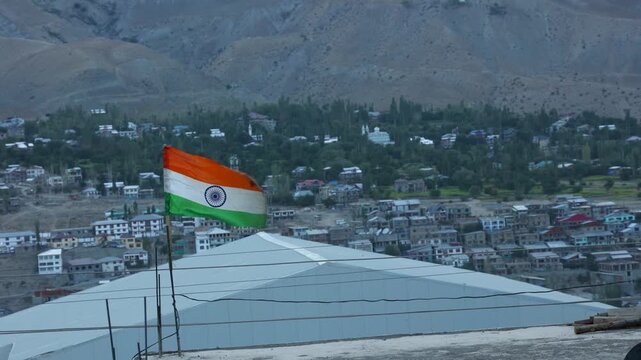 Indian flag in front of mountains in Padum town in Kargil District at Zanskar Valley, Ladakh, India. Indian flag waves in the kargil district Himalayas. Indian flag for Independence Day of India