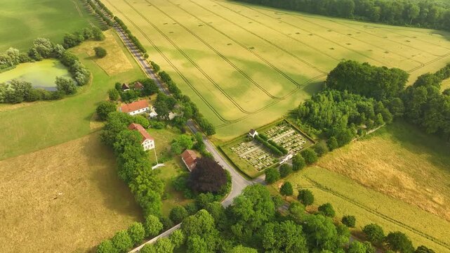 Aerial view of a country road and cemetery in a rural landscape