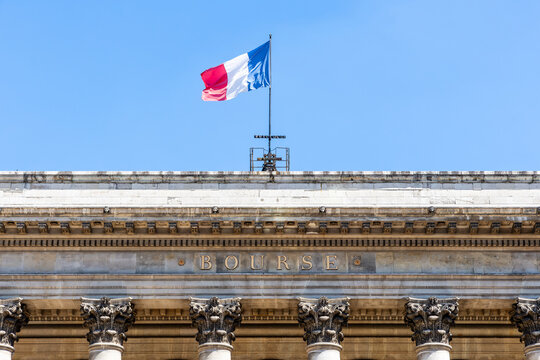 Paris, France - June 17, 2026: Close-up on the "Bourse" (Stock exchange) inscription in gilded letters on the 1826 Palais Brongniart, formerly Palais de la Bourse, with the French flag flying above.