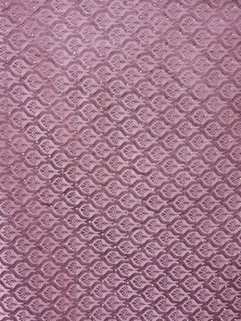 A textured lavender surface showcases intricate patterns, creating a visually appealing backdrop that evokes a sense of elegance and sophistication, suitable for various artistic applications.