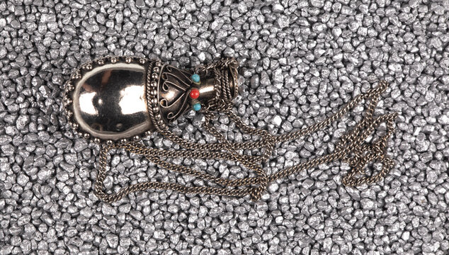 jewelry brooch isolated on silver sand