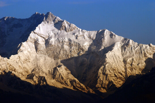 Kanchenjunga massif illuminated by the first rays of sunrise, viewed from Tiger Hill near Darjeeling, West Bengal, India