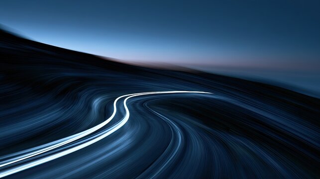 Blurred curving road at night with bright light trails against dark sky