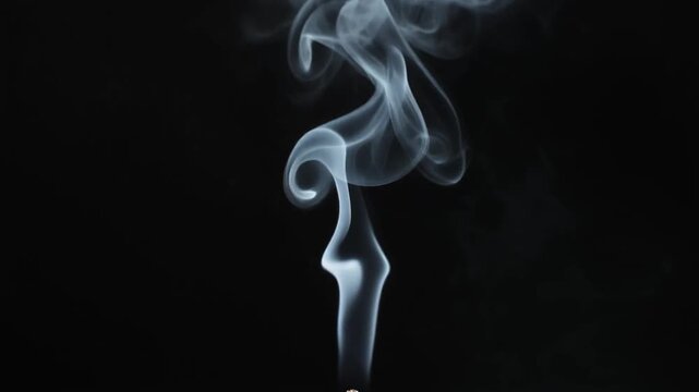 Glowing Wisps of Incense Smoke Swirl Upward in Darkness Cinematic Footage Rising Toward Peace and Serenity Perfect for Meditation Advertising and Wellness Presentations