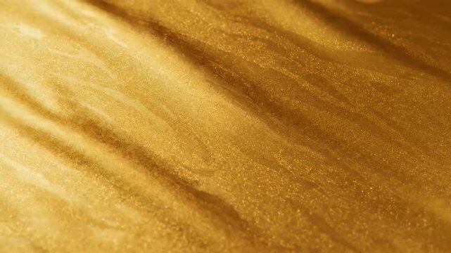 Abstract macro shot of shimmering golden liquid texture forming dynamic diagonal waves. Luxurious glitter and metallic flow background.
