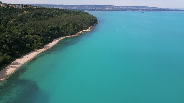 Aerial View of Turquoise Sea, Sandy Beach and Green Forest Coastline