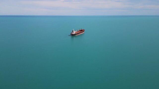 Aerial View of Cargo Ship Anchored in Calm Turquoise Sea