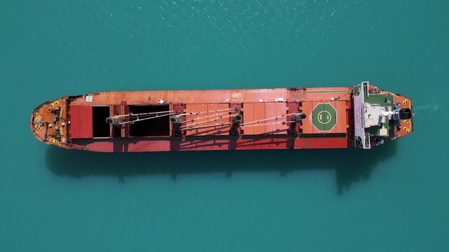 Top Down Aerial View of Cargo Ship in Turquoise Sea