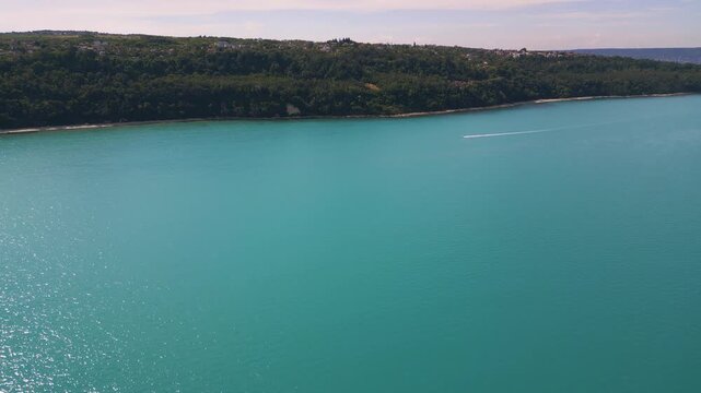 Aerial View of Turquoise Sea, Sandy Beach and Green Forest Coastline