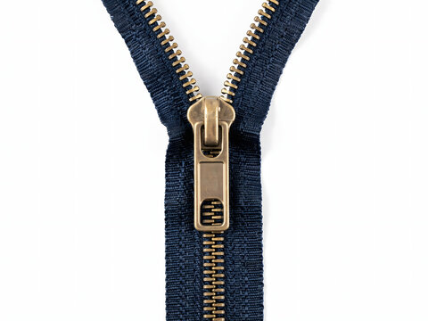 Zipper closure detail with gold slider and navy blue fabric, isolated on white background