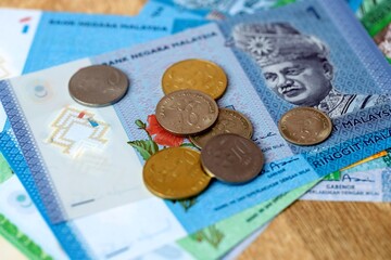 Malaysian ringgit money bills and coins on table. Malaysia cash of MYR currency close up © Larysa