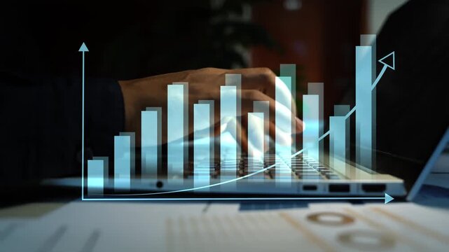 Businessman hands typing on a laptop with a glowing hologram bar chart animation on the screen, Holographic online business growth data analysis and financial progress in a dark office