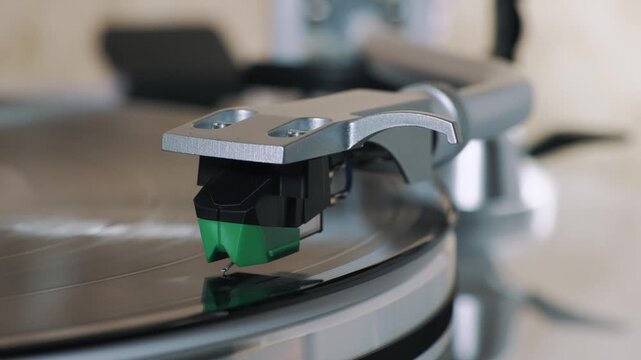 Turntable playing vinyl with stylus tracking LP groove, tonearm closeup, vintage analog audio, retro music playback.