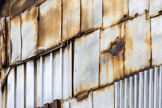 wall from old, rusty corrugated tin of hangar