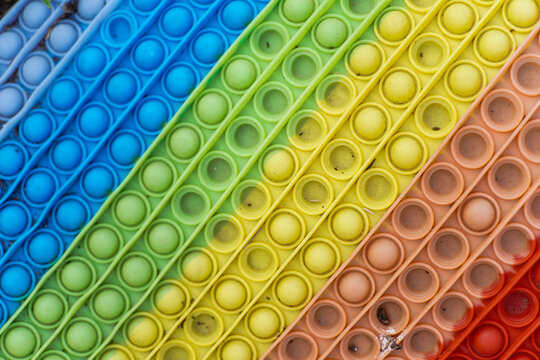Vibrant Rainbow Pop Fidget Toy with Diagonal Rows of Silicone Bubbles