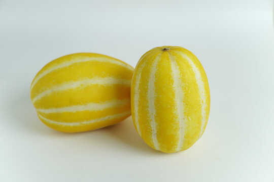 Vibrant Yellow Striped Korean Melons Isolated on a Clean White Background