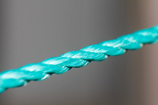 Close up Macro Shot of Vibrant Turquoise Braided Synthetic Rope Texture