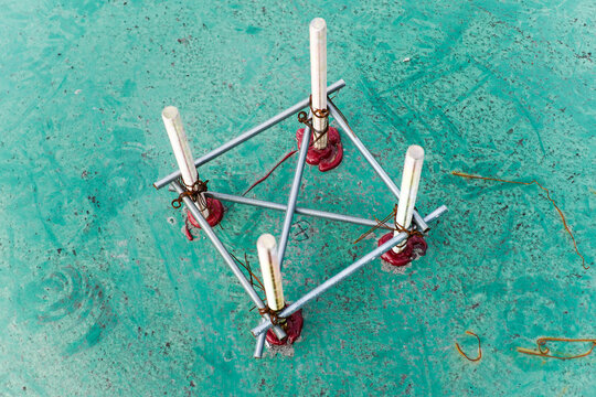 Industrial Anchor Bolts Secured with Sealant on a Textured Green Floor
