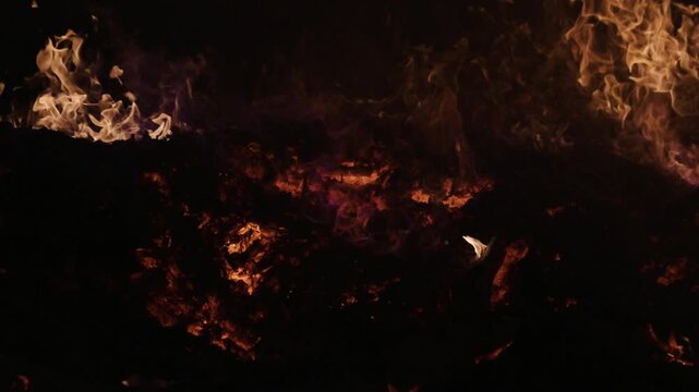Fire embers particles over black background. Fire sparks background. Abstract dark glitter fire particles lights. 4K Video.
