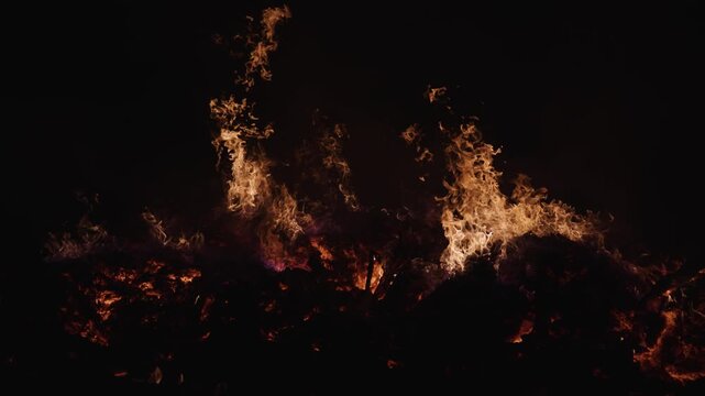 Fire embers particles over black background. Fire sparks background. Abstract dark glitter fire particles lights. 4K Video.
