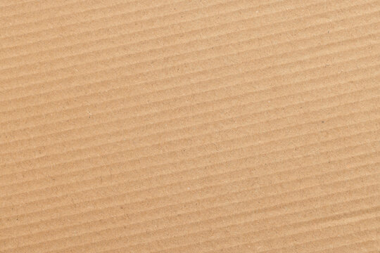 Close-up Texture of Brown Corrugated Cardboard,Macro,A high-resolution, full-frame top view of a rustic brown corrugated cardboard surface, showcasing its distinct ridged texture, natural fibrous.