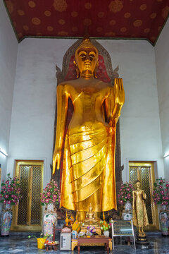 Bangkok, Thailand. December 14, 2013, Golden Buddha statue standing within a temple in Bangkok, Thailand, showing the religious and spiritual heritage