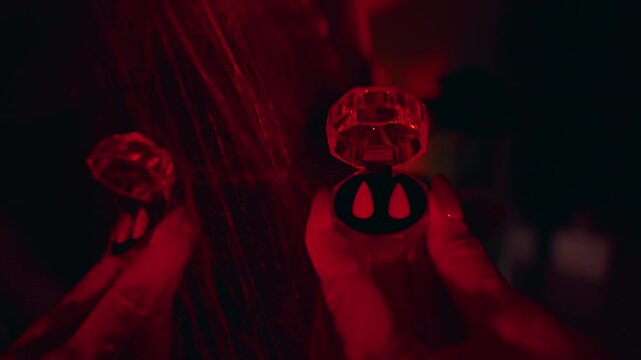 Mirror Reflection of Artificial Vampire Fangs in Decorative Case During Halloween Costume Preparation Under Red Light, Spooky Atmosphere, Horror Celebration
