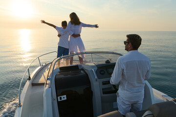 Fototapeta premium Family Enjoying Sunset Boat Ride on Calm Sea During Summer Vacation Together